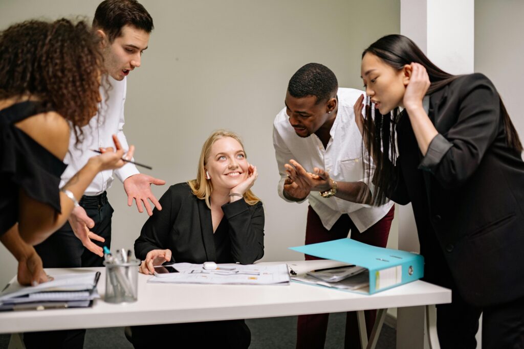 A diverse group of professionals engaged in an animated discussion at the workplace.